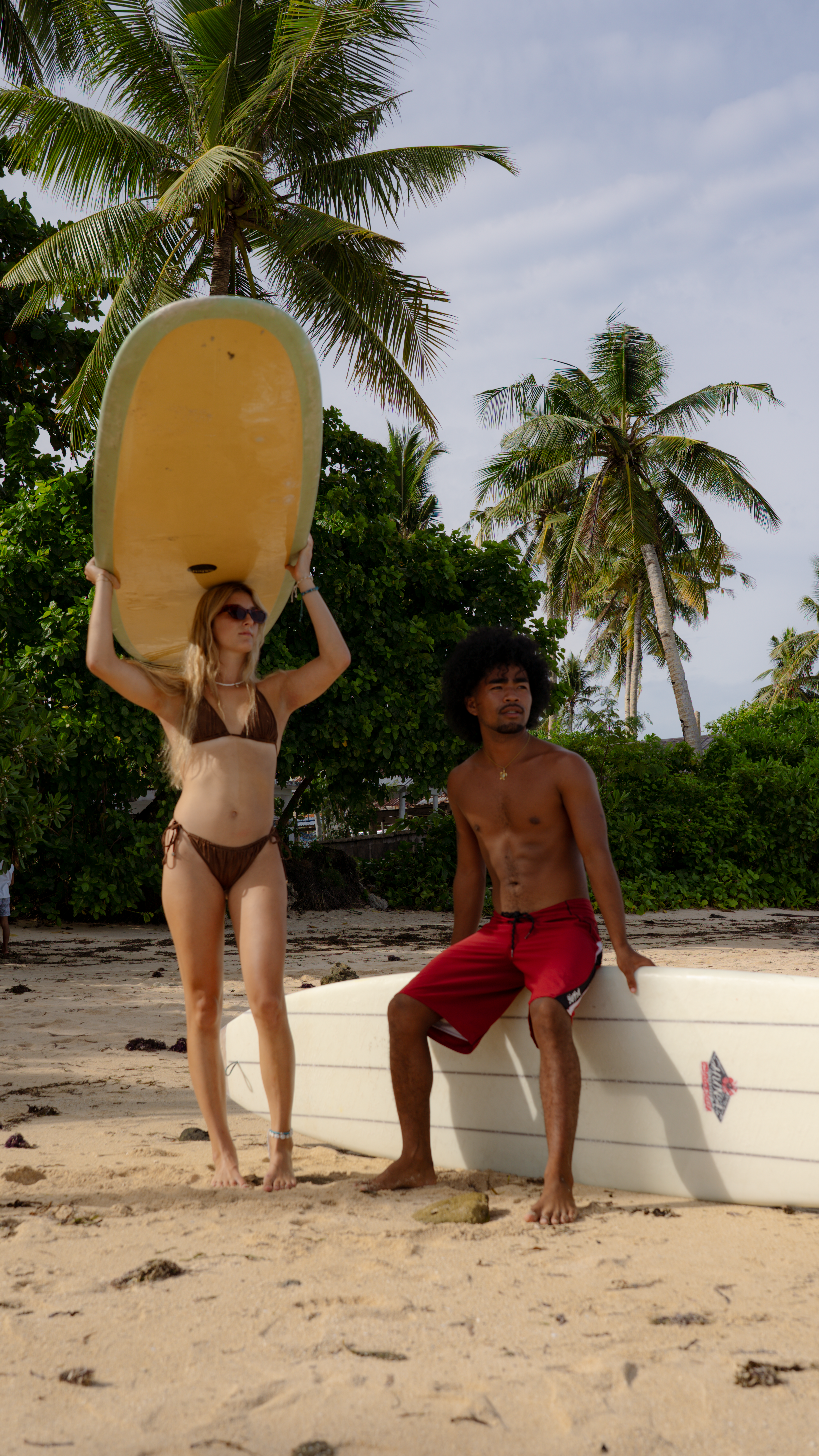 Surfers under palms