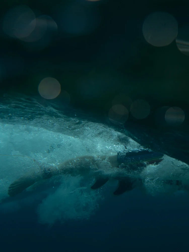 Underwater surf photography of a surfer paddling over a wave in Siargao