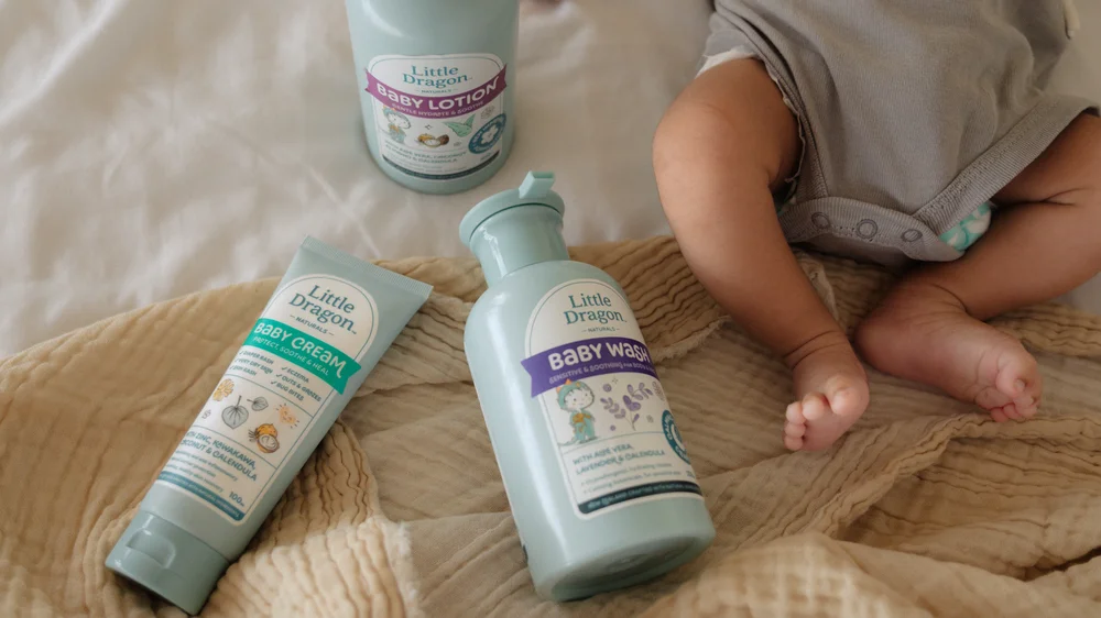 Little Dragon skincare product lineup on a styled wooden surface