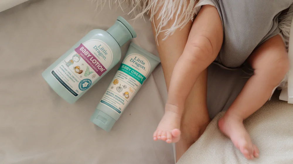 Lifestyle product photography of Little Dragon lotion and cream in a nursery setting